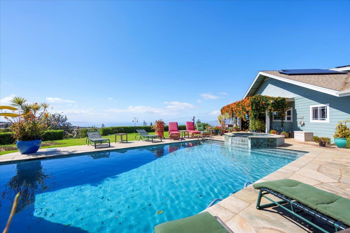 swimming pool view with two chairs