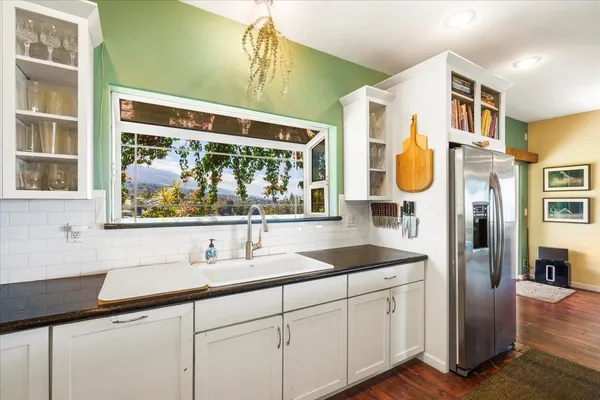 a kitchen with a sink cabinets and window