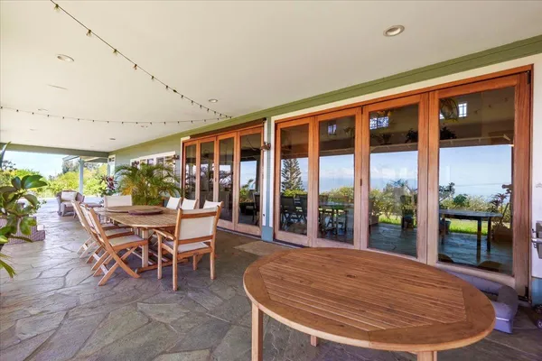 a outdoor space with a large window and dining table