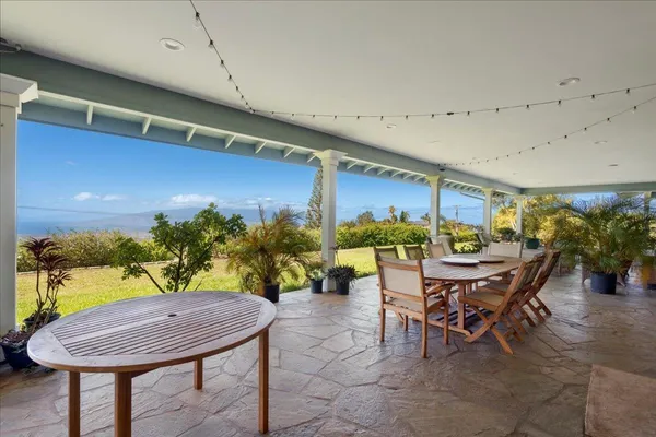 a view of a patio with a table and chairs