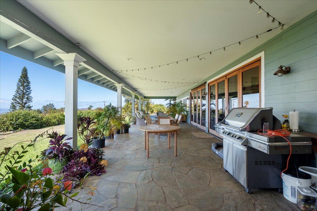40 Pulehu Road Kula, HI 96790 - Photo 17 of 49 a view of a porch with chairs and potted plants