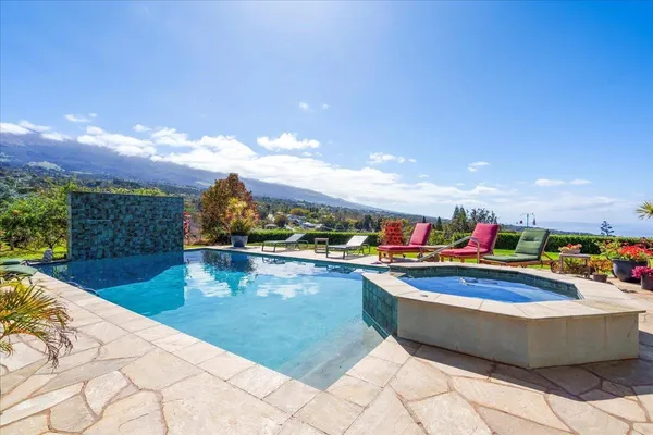 a view of a swimming pool and an outdoor seating