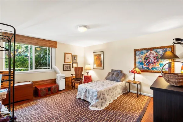 a bedroom with a bed and glass window