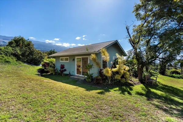 a view of a house with backyard sitting area and garden