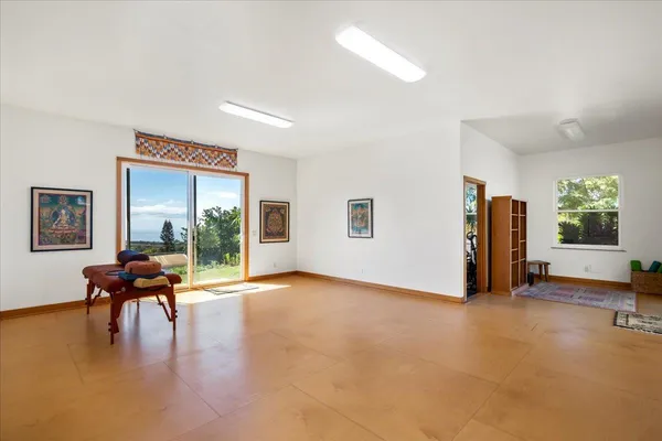 a view of a livingroom with furniture and a window