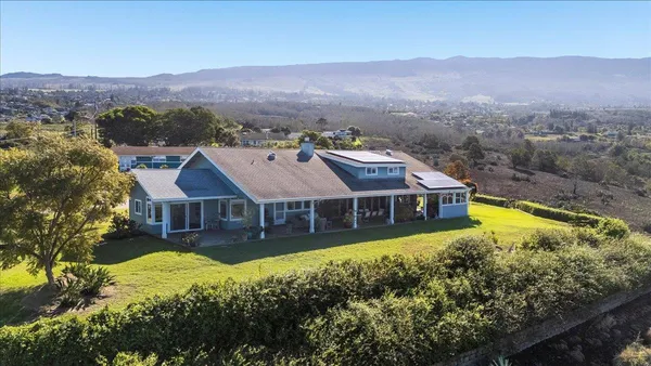 a view of a house with a mountain in the background