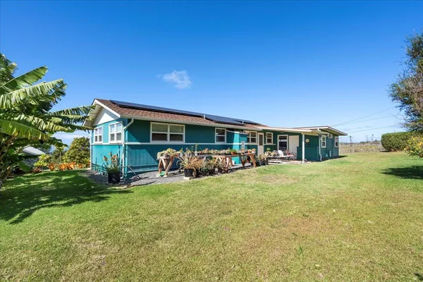 a view of a house with backyard porch and sitting area