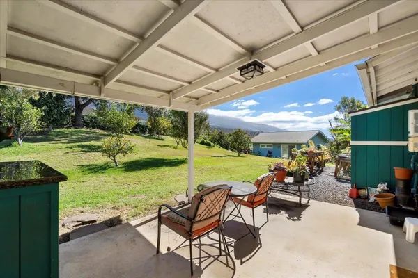 a view of swimming pool with outdoor seating and a garden