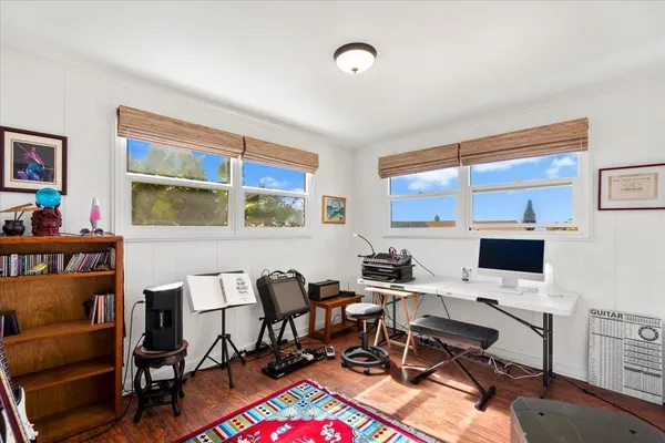 a view of a workspace with furniture and a window