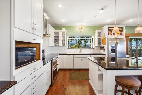 a kitchen with stainless steel appliances granite countertop a stove and a sink