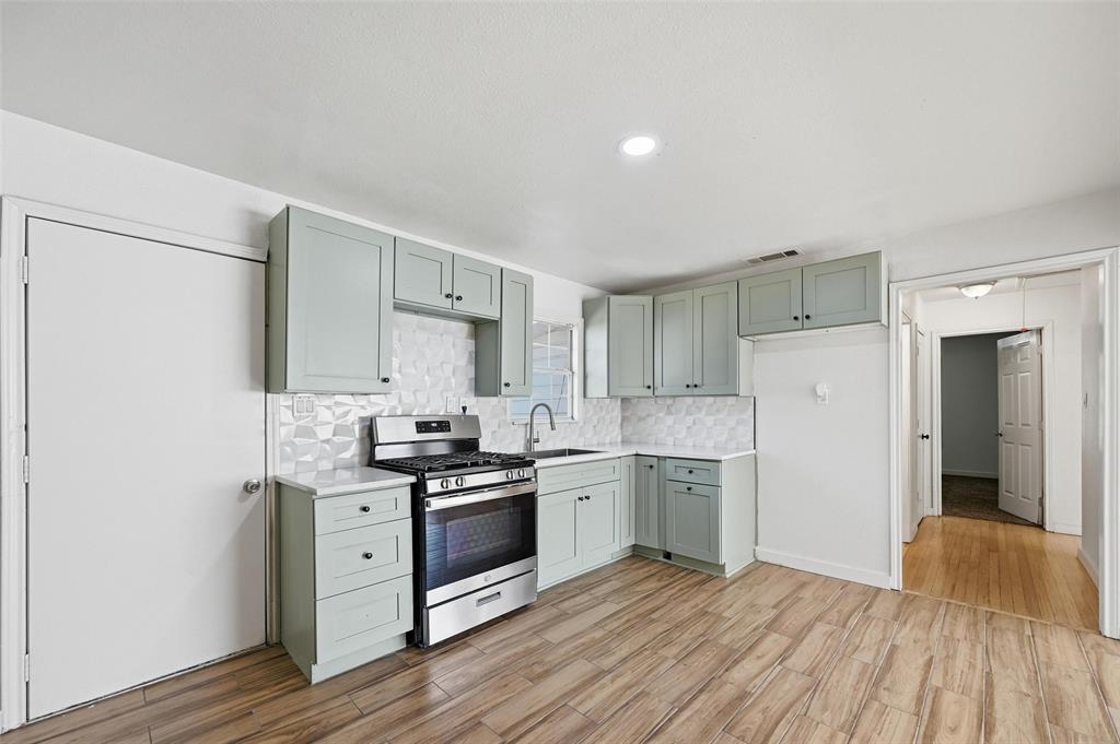 a kitchen with stainless steel appliances granite countertop a stove and a refrigerator