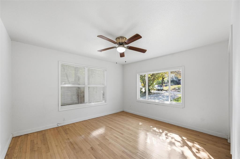 4310 Utah Avenue Dallas, TX 75216 - Photo 2 of 14 a view of an empty room with wooden floor and a window