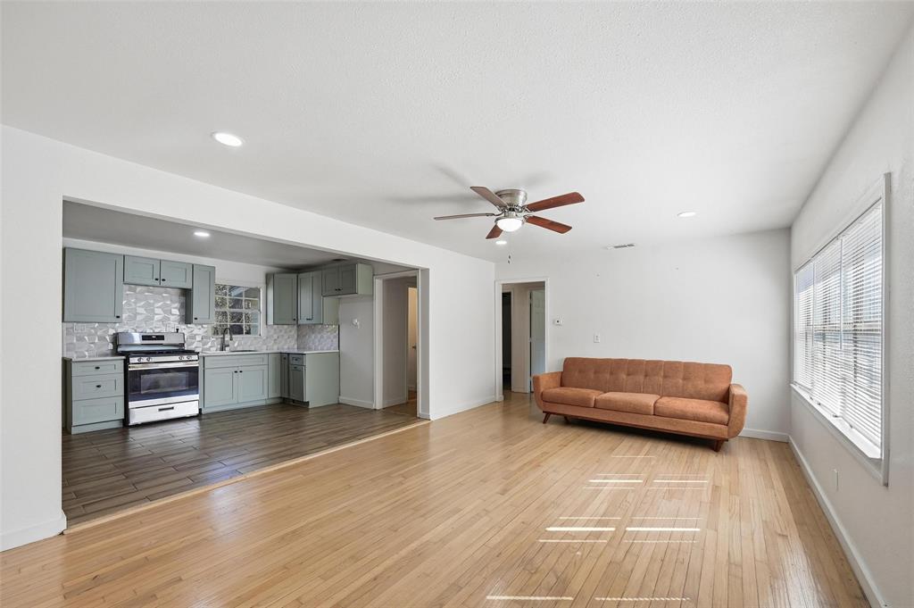 4310 Utah Avenue Dallas, TX 75216 - Photo 8 of 14 a living room with furniture and a wooden floor