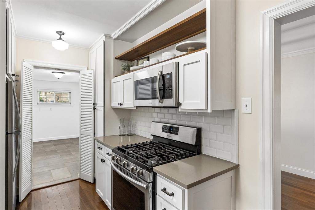 2427 Alco Avenue Dallas, TX 75211 - Photo 5 of 26 a kitchen with a stove and a microwave