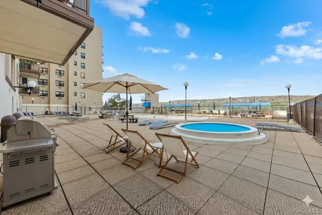 a view of a patio with a table and chairs