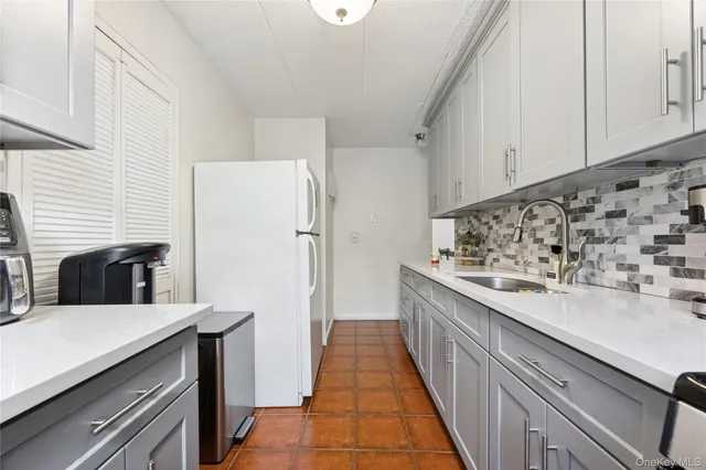 a kitchen with stainless steel appliances a refrigerator and a stove
