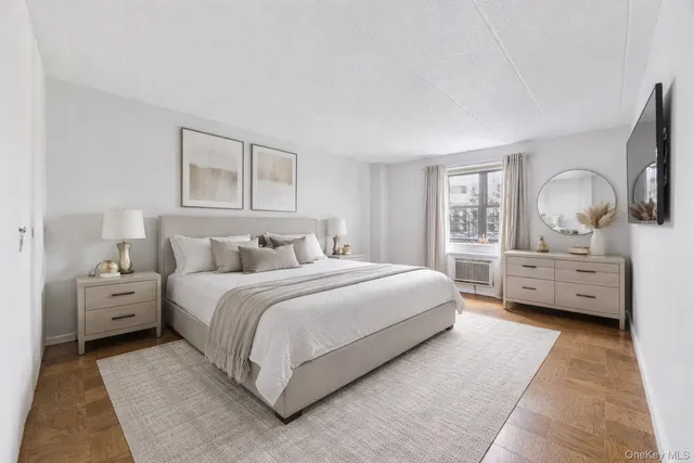 a spacious bedroom with a bed and a dresser