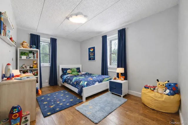 a living room with baby crib furniture and a window