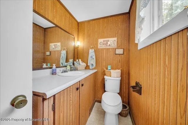 a bathroom with a toilet a sink and a mirror
