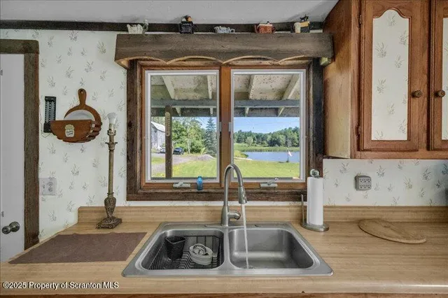a bathroom with a tub a sink and a window