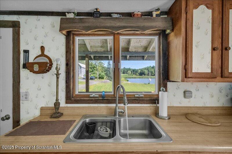 10846 Forest Lake Road Montrose, PA 18801 - Photo 14 of 42 a bathroom with a tub a sink and a window