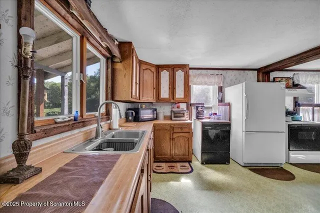 a kitchen with refrigerator and window