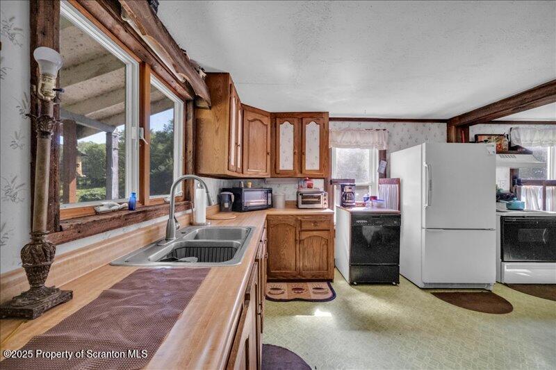 10846 Forest Lake Road Montrose, PA 18801 - Photo 17 of 42 a kitchen with refrigerator and window