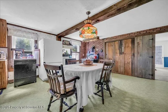 a view of a dining room with furniture and window