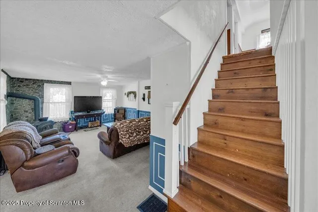 a living room with furniture and stairs