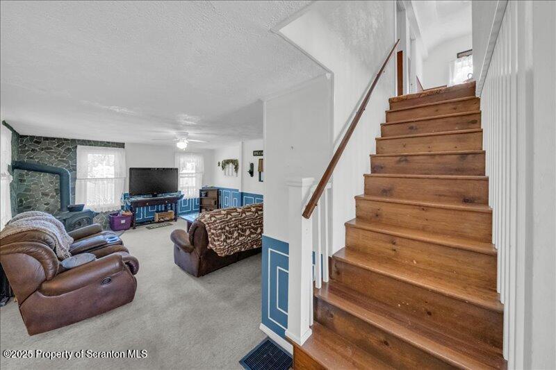 10846 Forest Lake Road Montrose, PA 18801 - Photo 19 of 42 a living room with furniture and stairs