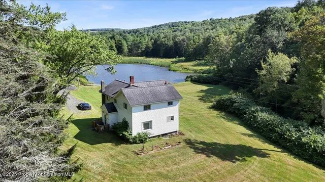 an aerial view of a house with a yard