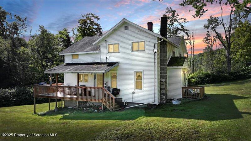10846 Forest Lake Road Montrose, PA 18801 - Photo 3 of 42 a front view of a house with a garden