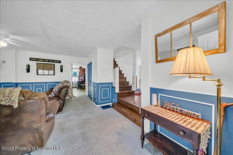 10846 Forest Lake Road Montrose, PA 18801 - Photo 5 of 42 a living room with furniture a flat screen tv and a large window
