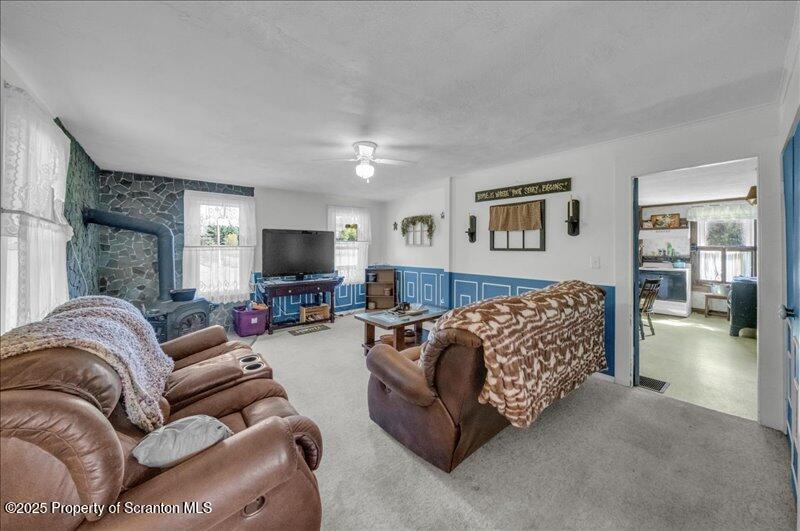 10846 Forest Lake Road Montrose, PA 18801 - Photo 6 of 42 a living room with furniture and a flat screen tv