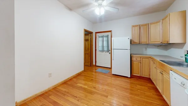 a view of a kitchen with a sink and cabinet