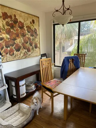 a view of a dining room with furniture window and wooden floor