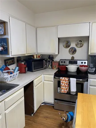 a kitchen with stainless steel appliances granite countertop a stove and cabinets