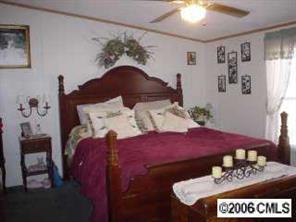 205 Apple Road Salisbury, NC 28147 - Photo 3 of 8 a bedroom with furniture and a chandelier