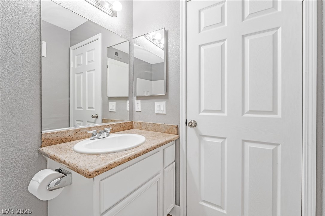3318 North Decatur Boulevard, Unit 2152 Las Vegas, NV 89130 - Photo 19 of 58 A well-appointed bathroom vanity with a spacious counter and mirrored wall.