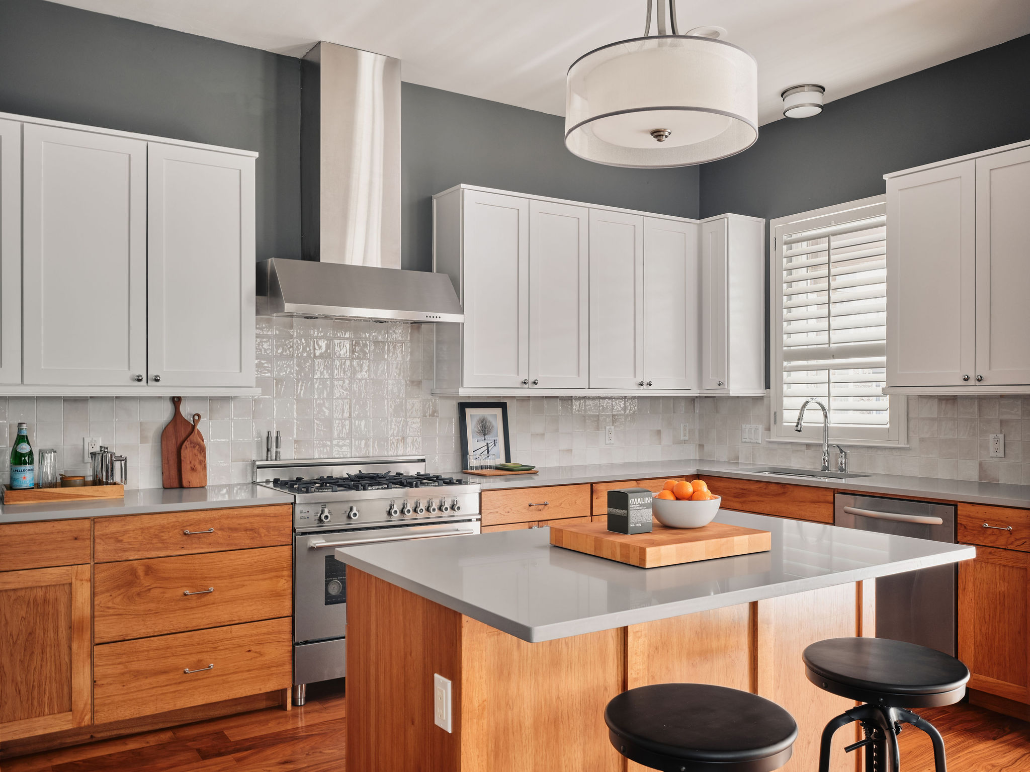 1504 Collier Street, Unit 4 Austin, TX 78704 - Photo 2 of 38 Kitchen featuring stainless steel appliances, a kitchen island, light wood-style floors, a breakfast bar, and pendant lighting