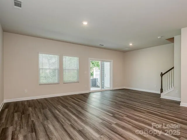 a large kitchen with stainless steel appliances refrigerator sink and cabinets