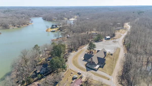 a living room with lots of furniture a chandelier and a large window