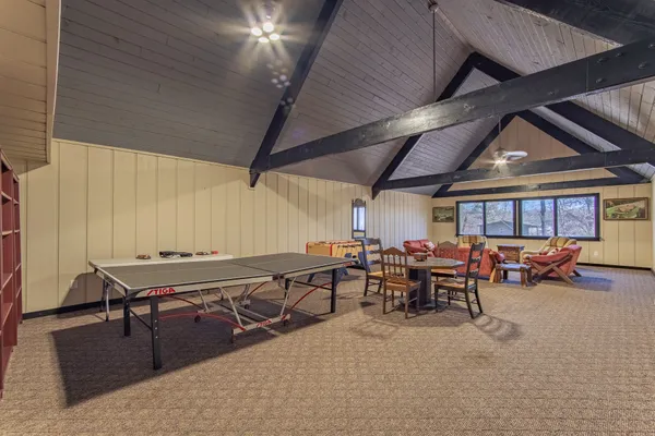 a view of a living room with hardwood floor and a ceiling fan
