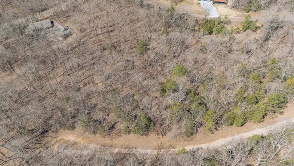 an aerial view of a house with a yard and lake view
