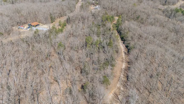 an aerial view of a house with a lake view