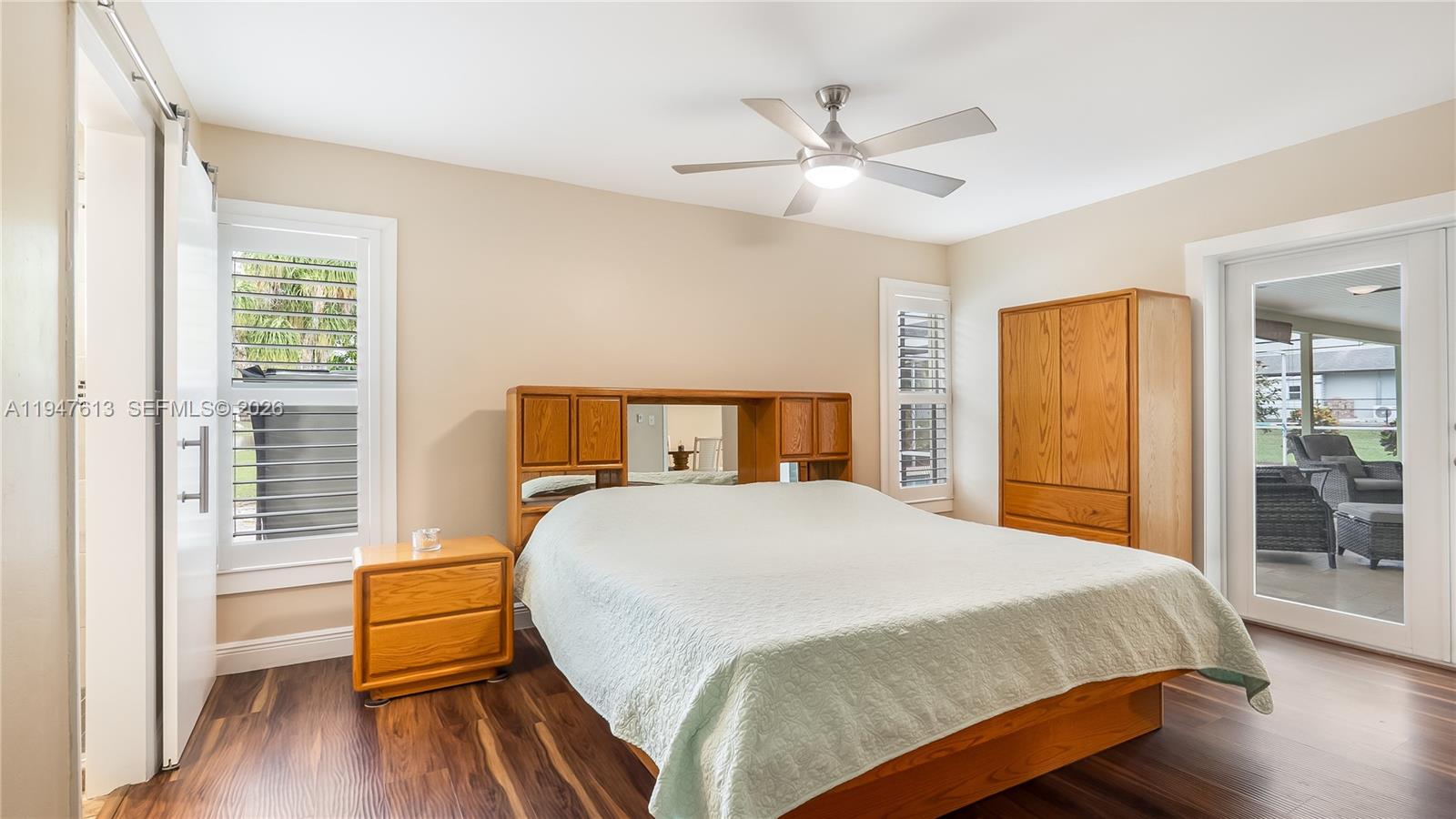 11071 Southwest 30th Court Davie, FL 33328 - Photo 14 of 44 a bedroom with a bed and wooden floor