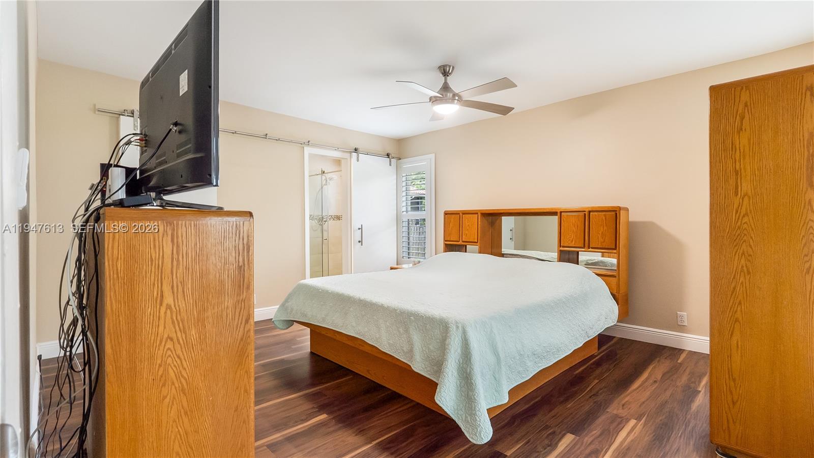 11071 Southwest 30th Court Davie, FL 33328 - Photo 15 of 44 a bedroom with a bed and wooden floor