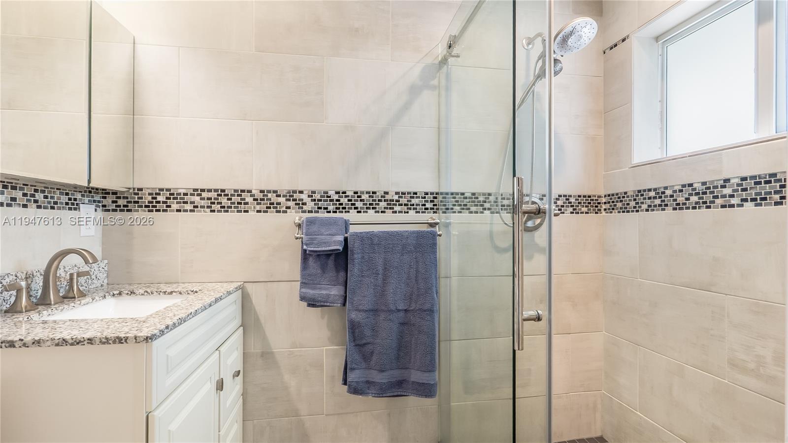 11071 Southwest 30th Court Davie, FL 33328 - Photo 18 of 44 a bathroom with a granite countertop shower sink vanity and mirror