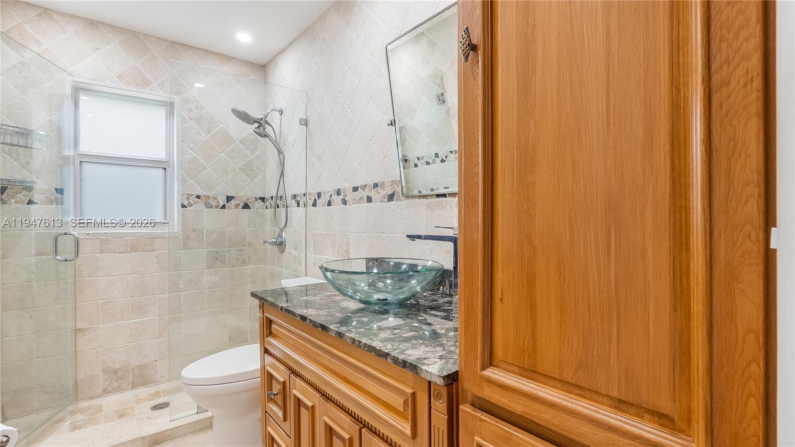 11071 Southwest 30th Court Davie, FL 33328 - Photo 21 of 44 a bathroom with a granite countertop sink toilet and shower