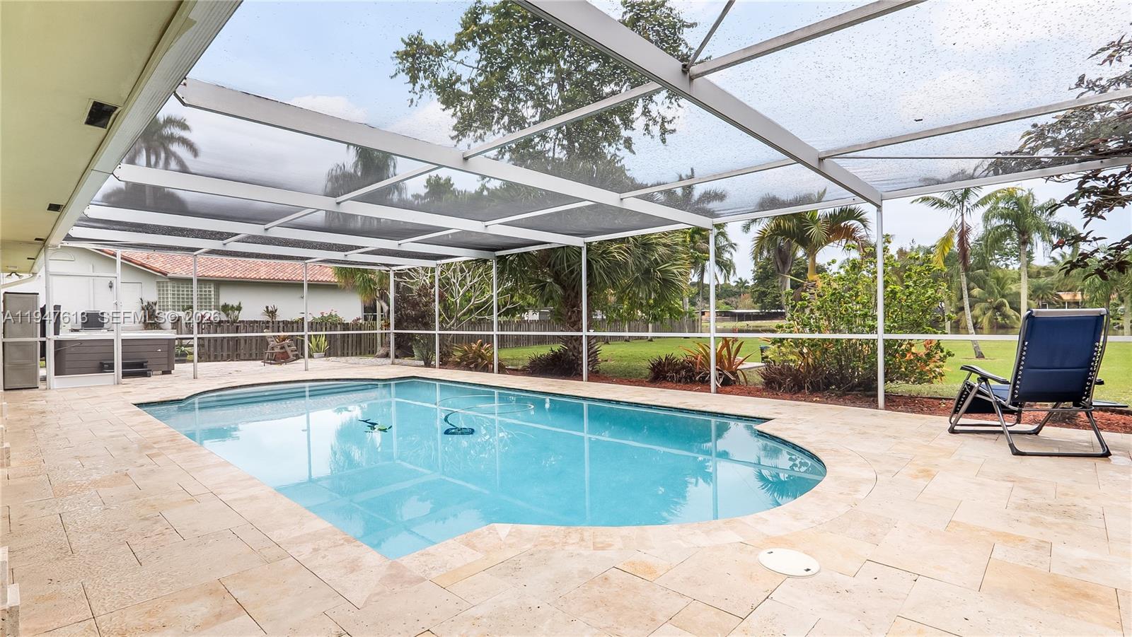 11071 Southwest 30th Court Davie, FL 33328 - Photo 28 of 44 a view of a swimming pool with a lounge chair